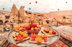 Travel in Cappadocia Colorful hot air balloons flying over the valley sunrise time with 
special breakfast travel destination in Turkey